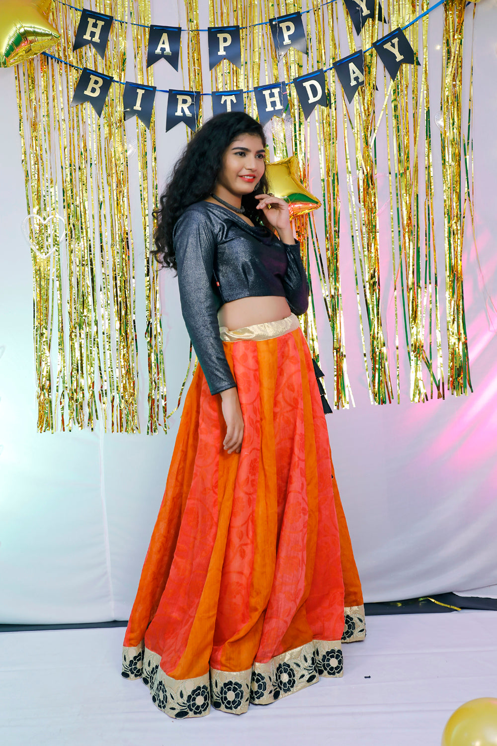 Black full sleeves blouse and orange lehenga.