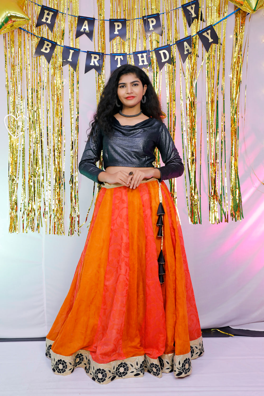 Black full sleeves blouse and orange lehenga.