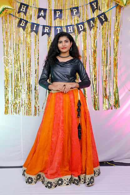 Black full sleeves blouse and orange lehenga.