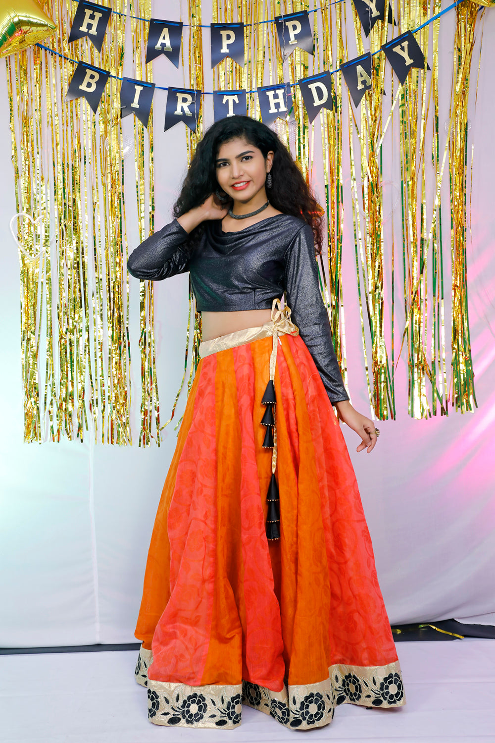 Black full sleeves blouse and orange lehenga.