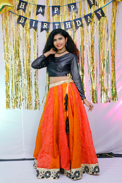 Black full sleeves blouse and orange lehenga.