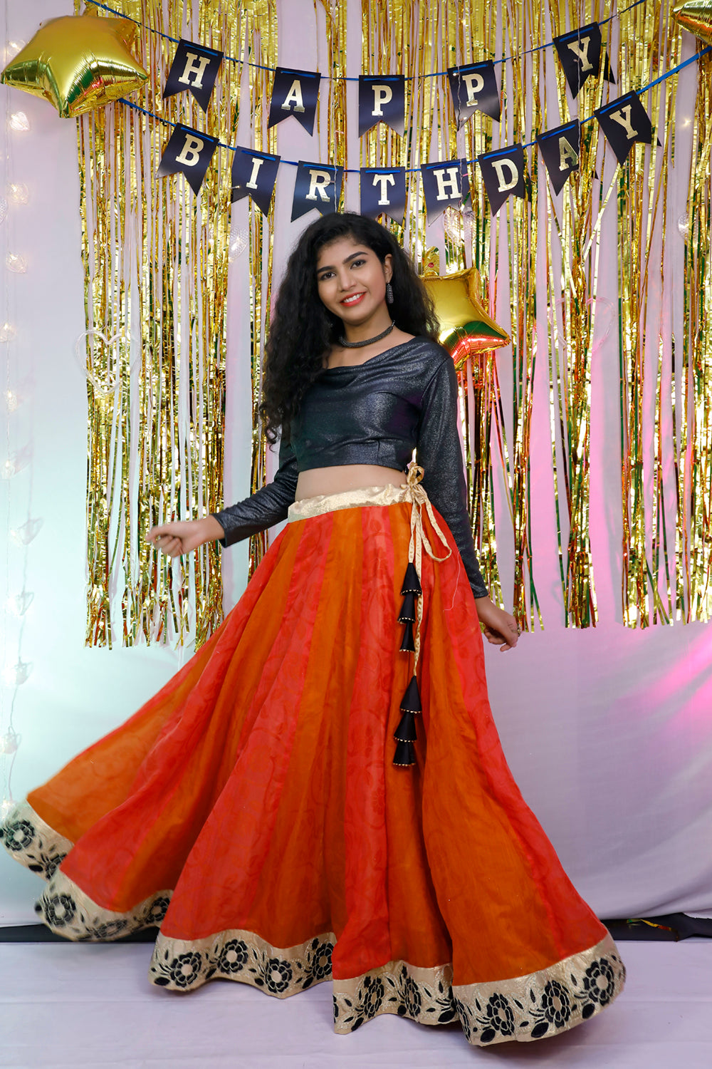 Black full sleeves blouse and orange lehenga.