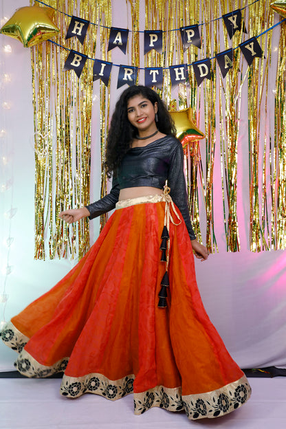Black full sleeves blouse and orange lehenga.