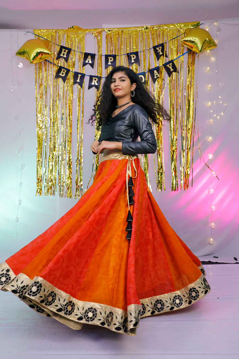 Black full sleeves blouse and orange lehenga.