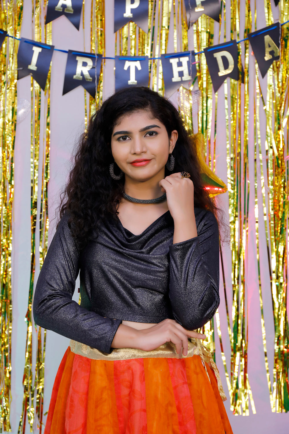 Black full sleeves blouse and orange lehenga.